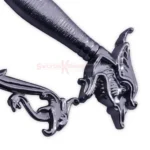 Close-up of the decorative silver crossguard and dark textured grip on the Dragon Scimitar.