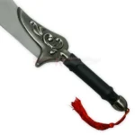 Close-up of the black handle and decorative guard of the Auron Katana replica with a red tassel.