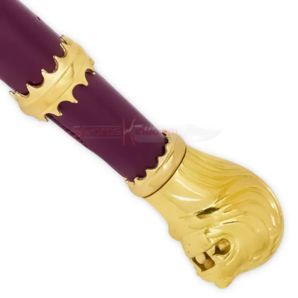 Close-up of the burgundy-wrapped handle featuring gold decorative fittings and a lion-shaped gold pommel.