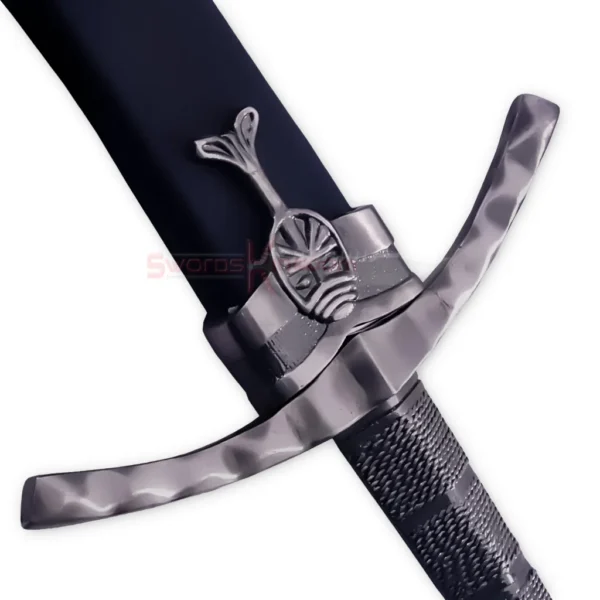 Close-up of the Ibelin sword replica hilt showing the curved crossguard, dark textured handle and decorative pommel.