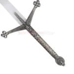 Detailed view of the ornate dark metal crossguard and engraved handle of the Black Knight Claymore sword.