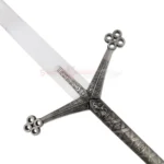 Close-up view of the silver blade and detailed crossguard of a medieval Black Knight Claymore sword.