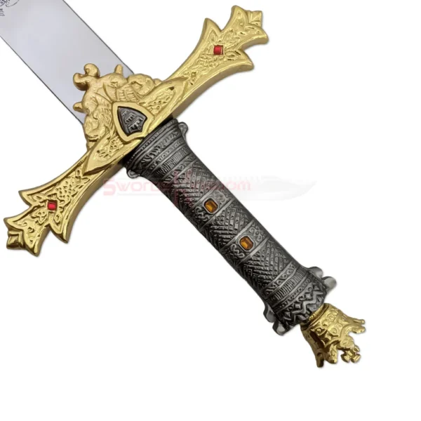Detailed view of the hilt of the King Arthur Excalibur Sword in the Stone Gold Edition replica featuring a ornate gold crossguard with red jewels, textured grip, and crown pommel